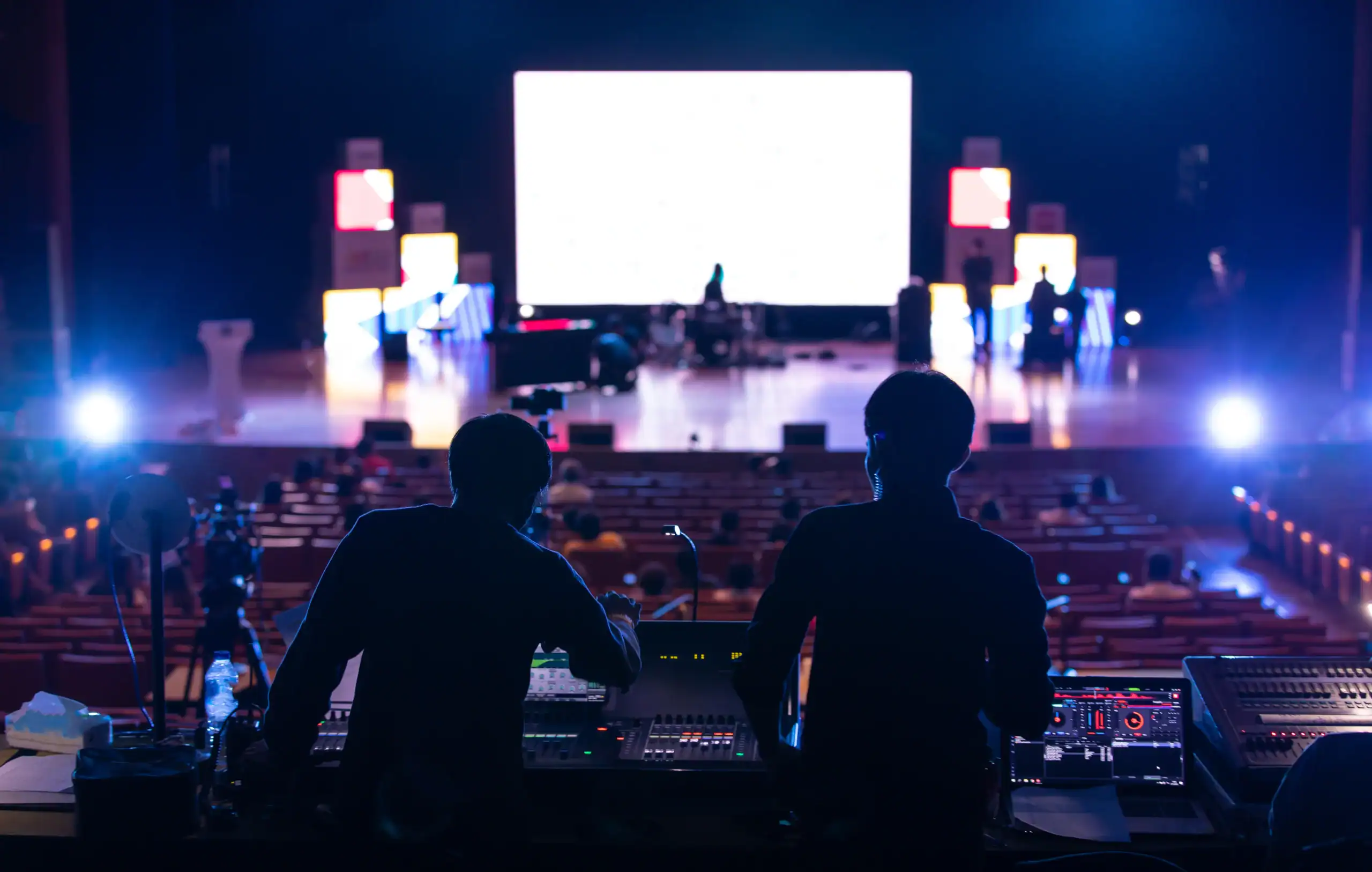 Two sound engineers working at a concert event in Texas.